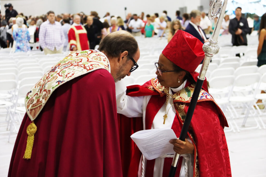 Bishop Wells offers Bishop Seage a blessing after the recession at her ordination and consecration service at St. Andrew’s Episcopal School on July 20, shortly after he handed over the crozier and episcopacy of the Diocese of Mississippi to her. To read more about the ordination weekend, see page 5. Photo by Wil Oakes